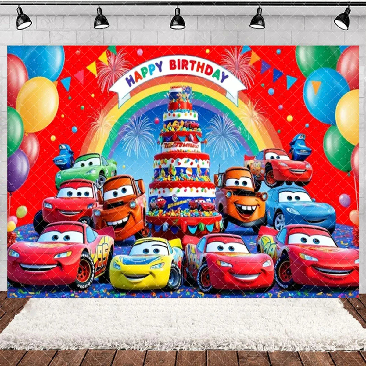 A vibrant cartoon racing birthday party backdrop featuring colorful cars and a tiered cake against a rainbow background.