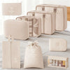 A set of beige and cream fabric travel storage organizers, including pouches and a box.