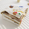 A white quilt featuring cute brown and white bear designs with the text Gummy All we have