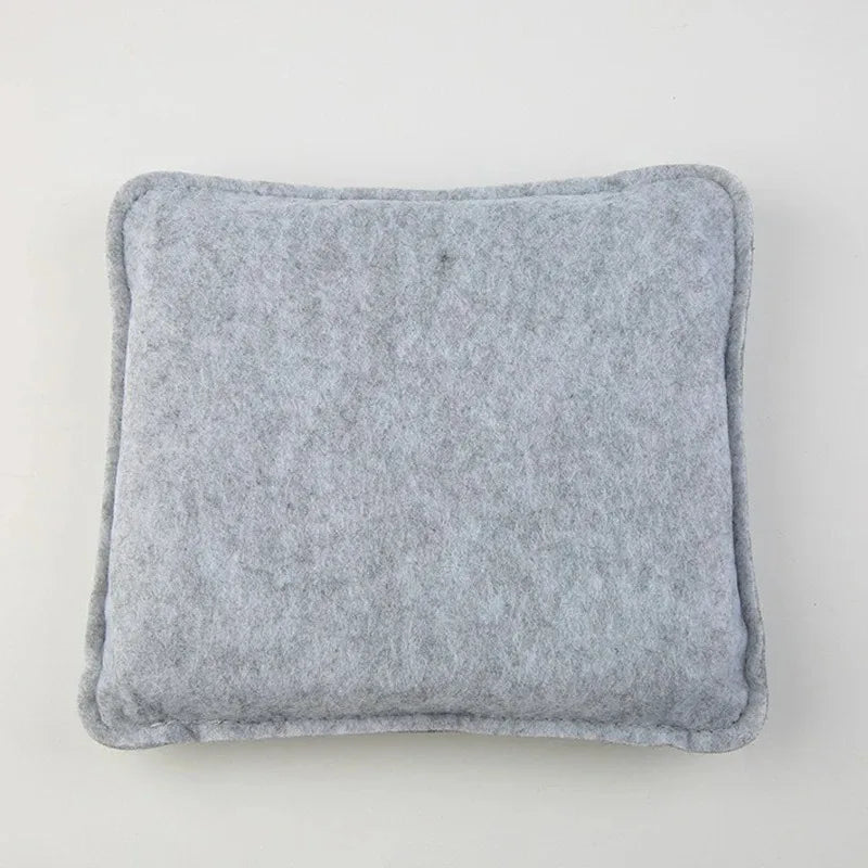 A square, gray needle felting mat pad with rounded edges.
