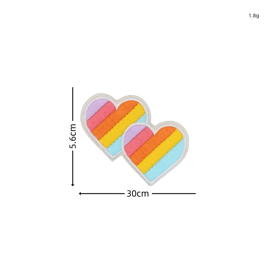 A set of ten embroidered heart-shaped patches featuring a rainbow color pattern.