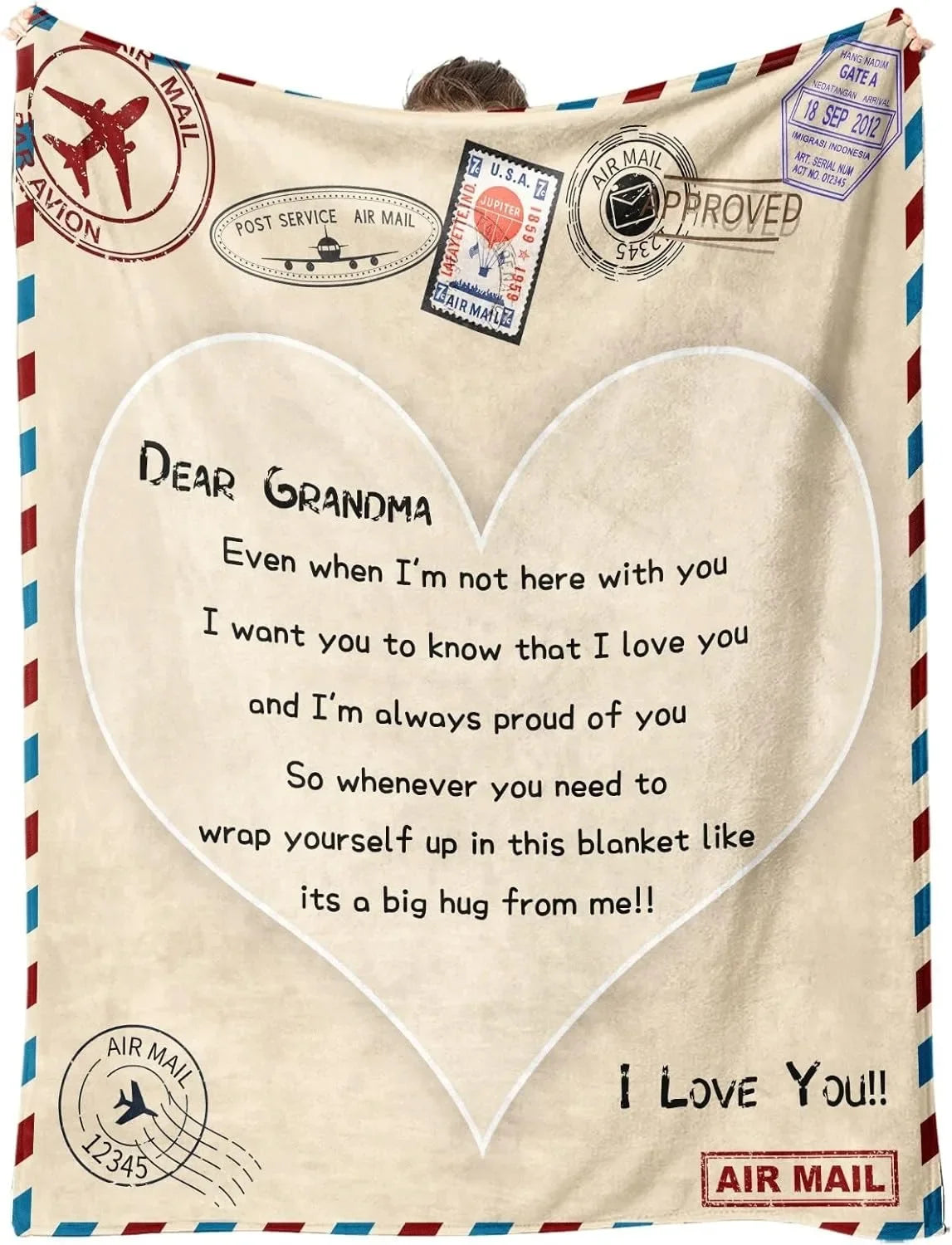 A beige knit blanket featuring a heart design and text expressing love and pride for a grandma