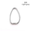 A silver light grey braided tieback clip for hair.