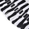 A collection of black and white embroidery floss threads laid out in a line.