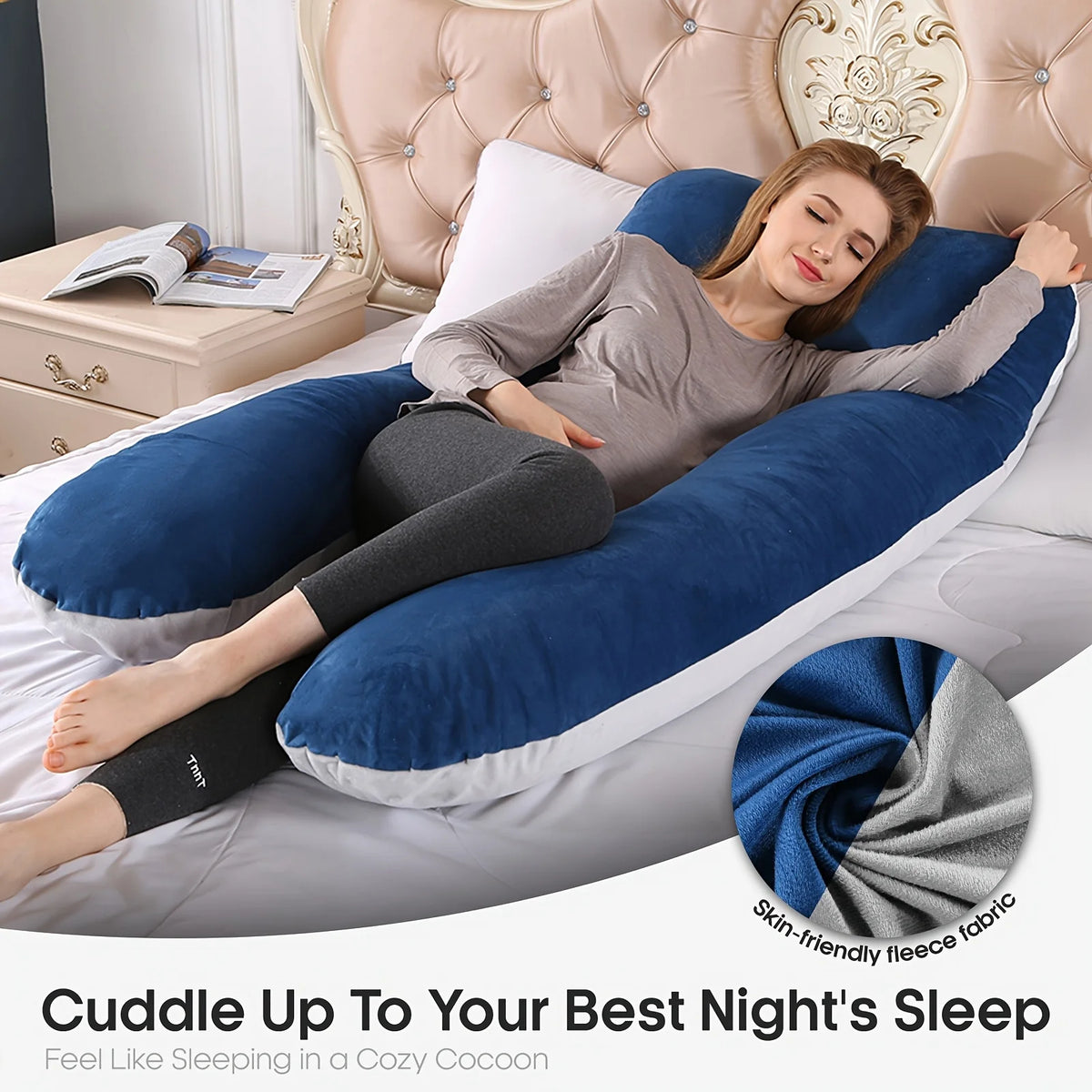 A woman is relaxing on a bed with a blue and gray U-shaped memory foam pillow for sleep.