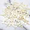 A pile of small, cream-colored satin ribbon bows for crafts and decor.