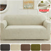 A beige sofa slipcover featuring a woven jacquard leaf pattern on a light-colored wall.