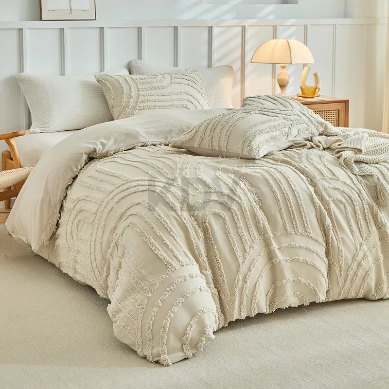 A beige embossed floral duvet cover set with matching pillowcases displayed on a bed.