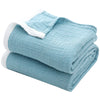 Light blue breathable 4-layer muslin throw blanket folded and rolled