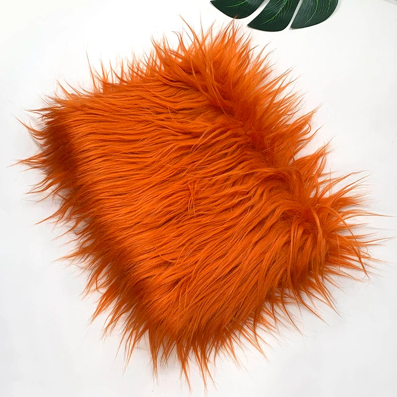 A fluffy orange faux fur fabric used for sewing and crafting.
