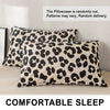 Two leopard print pillowcases with a beige and black pattern are displayed on a light-colored surface.
