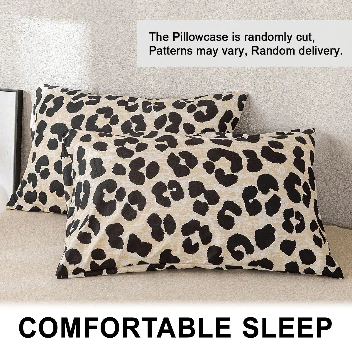 Two leopard print pillowcases with a beige and black pattern are displayed on a light-colored surface.