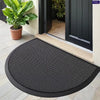 Black half-round non-slip PVC door mat placed on a light-colored tiled floor near a dark door.