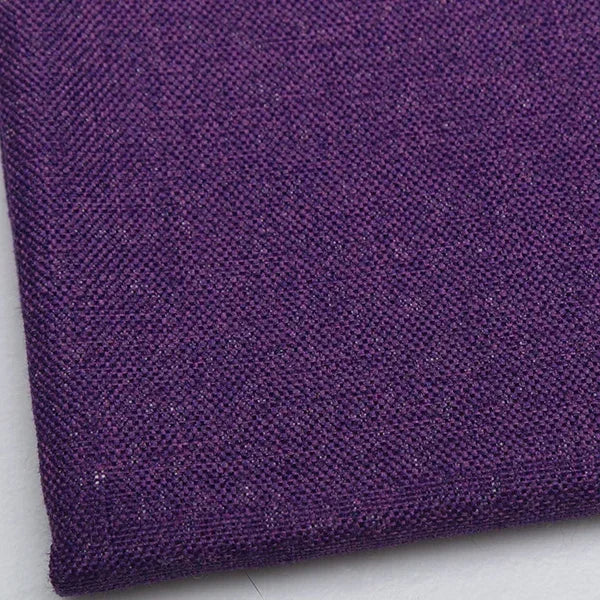 A close-up of a deep purple coarse linen and cotton fabric textile.