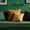 A sofa decorated with yellow and dark green pillows in a modern room.