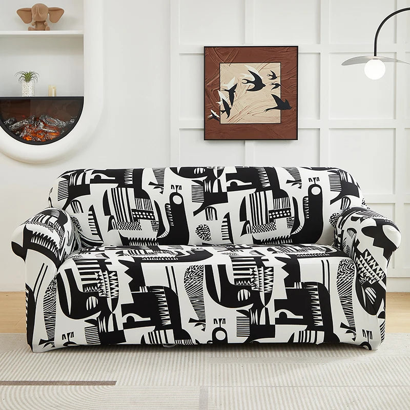 A black and white patterned stretch floral elastic sofa cover displayed on a light-colored floor.