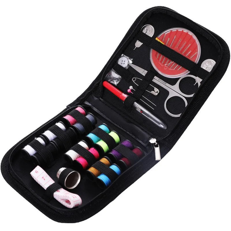 A black portable sewing kit case containing various tools, including scissors, needles, and spools of thread.