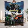A Monster Jam flannel throw blanket featuring images of monster trucks and a large monster truck.