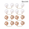 A set of eight pearl-like round jewelry pieces with gold-toned findings.