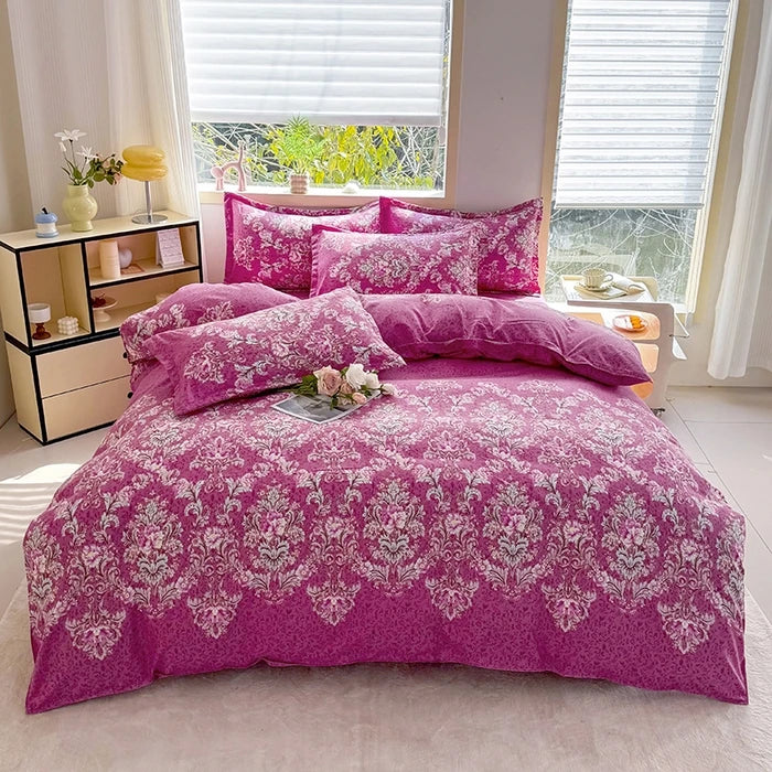 A pink marble print duvet cover set with matching pillowcases displayed on a bed in a bright room.