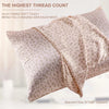 A light pink leopard print satin pillowcase is shown folded, highlighting the silky fabric texture.
