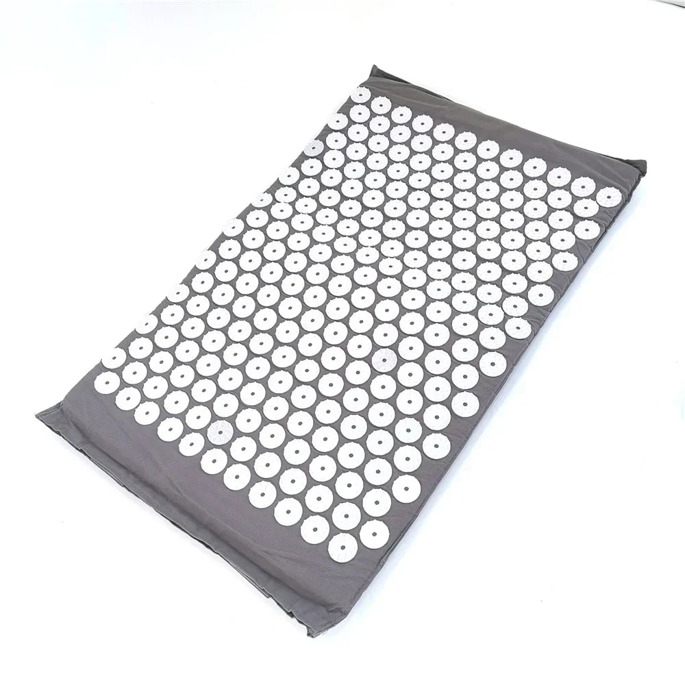 A gray acupressure relief mat with numerous white, circular bumps for pain and stress relief.