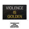 Black embroidered patch with yellow text that reads Violence is Golden