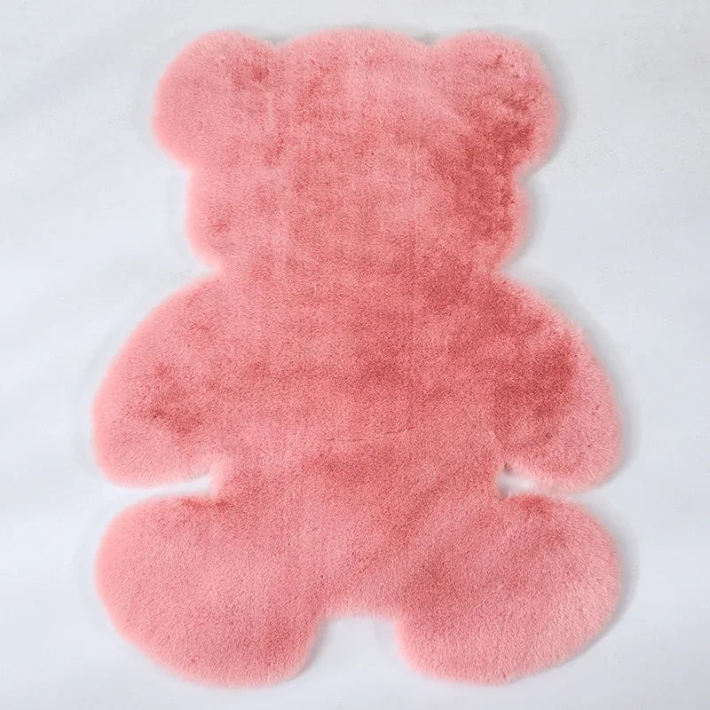 A pink plush bear-shaped non-slip area rug.