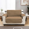 A beige waterproof anti-slip sofa slipcover displayed on a white wooden cabinet.