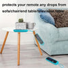A silicone remote cover with a lanyard is placed on a white table next to a sofa.