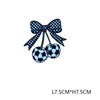 Black and white soccer ball embroidery with a black bow on a green thread.