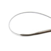 A set of stainless steel circular knitting needles lying on a white background.