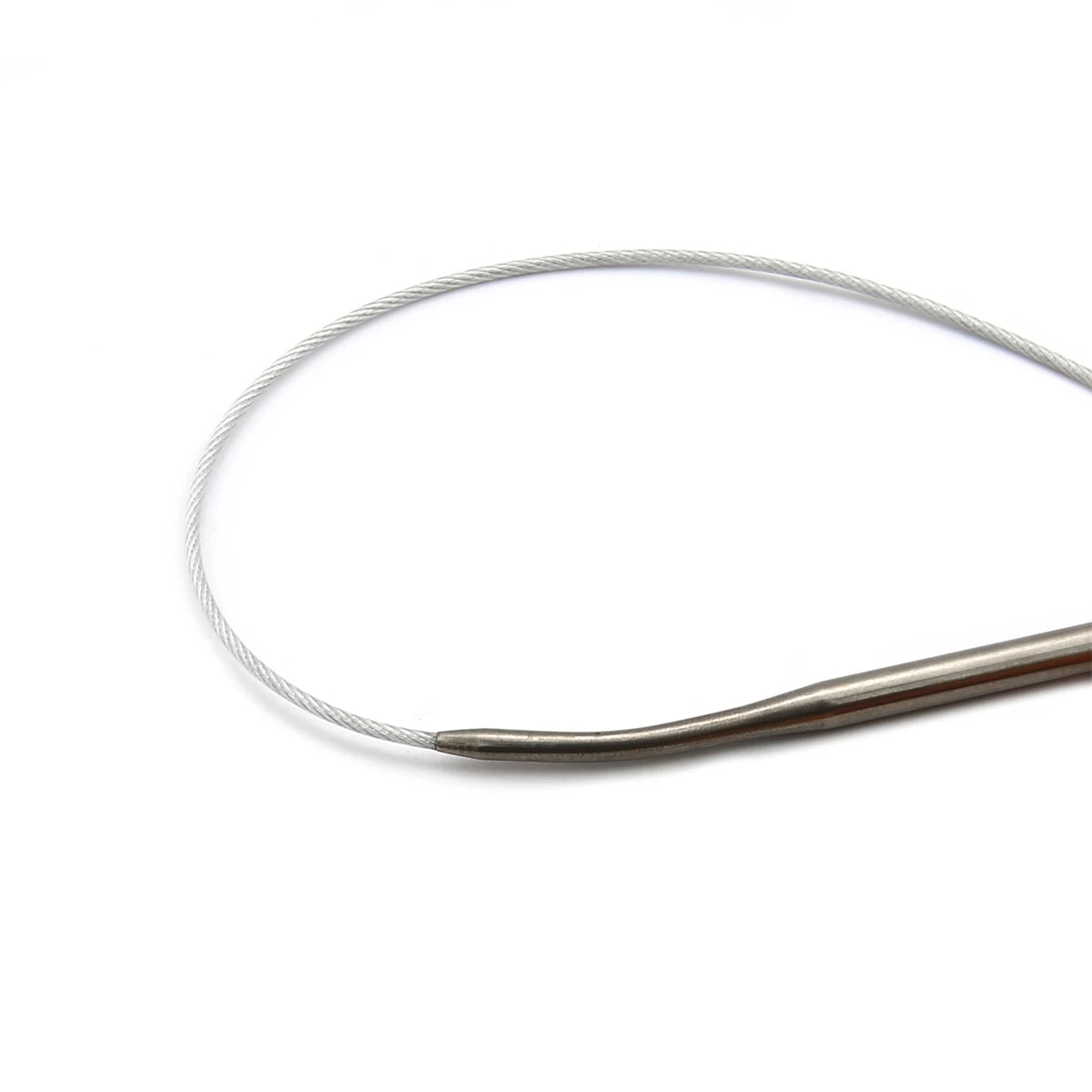 A set of stainless steel circular knitting needles lying on a white background.