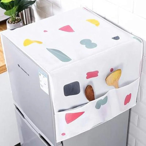A reusable waterproof dust cover with colorful shapes is placed over a silver refrigerator.