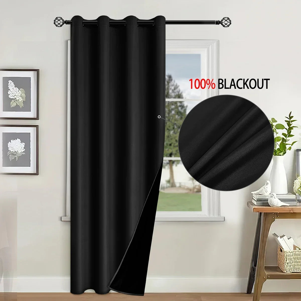 A black blackout curtain hanging in a window frame, demonstrating light blocking.