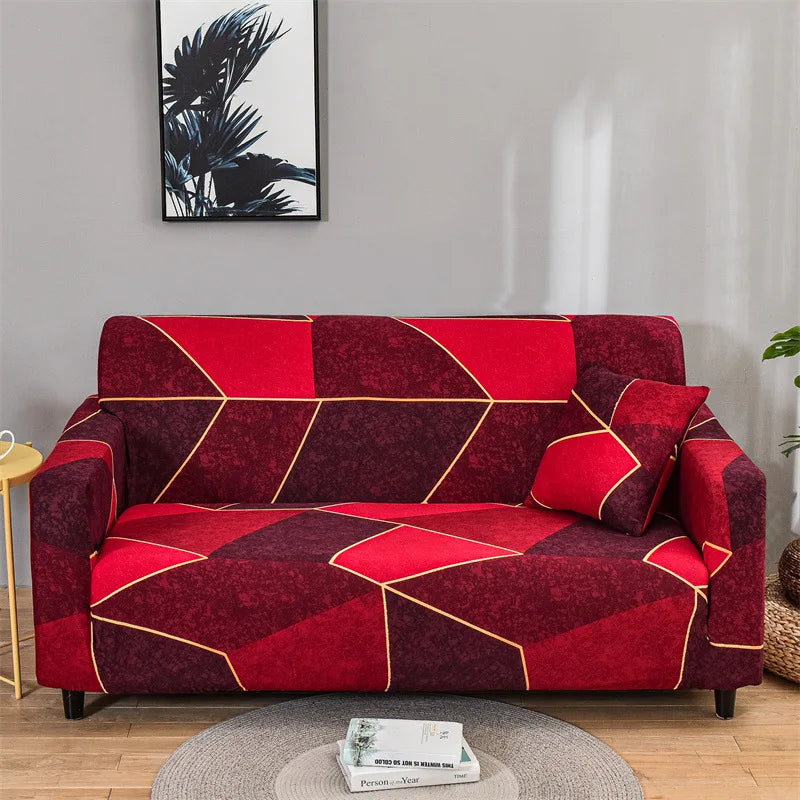 A deep red and maroon patterned elastic sofa cover protector displayed on a gray wall.