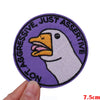 Purple embroidered patch featuring a white duck with text reading Not Aggressive Just Assertive