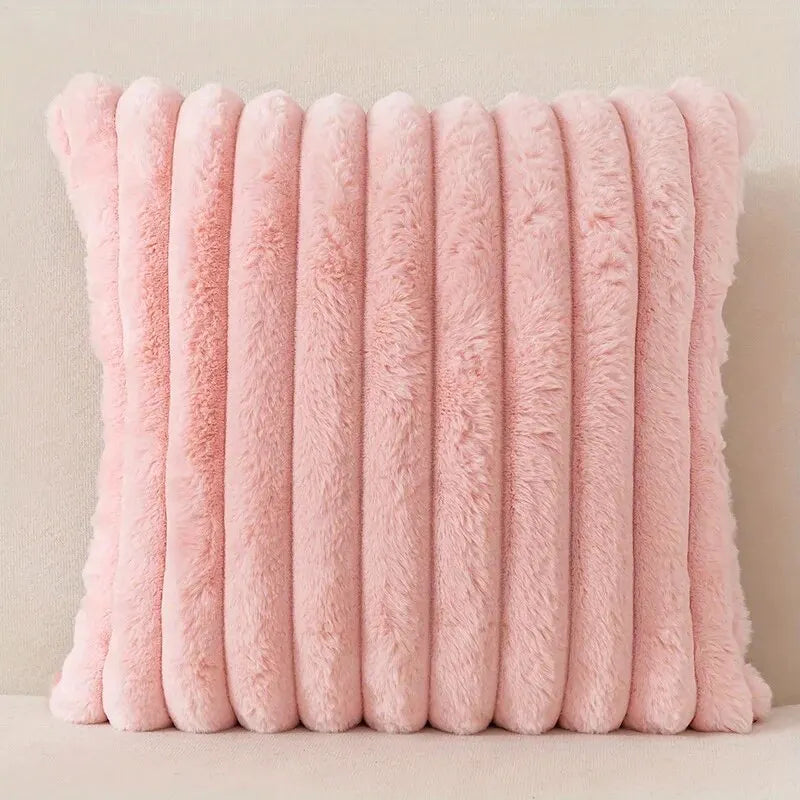 A stack of pink faux fur stripe corduroy pillow covers arranged vertically.
