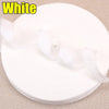 White iron-on hem tape for pants and jeans rolled up on a beige surface