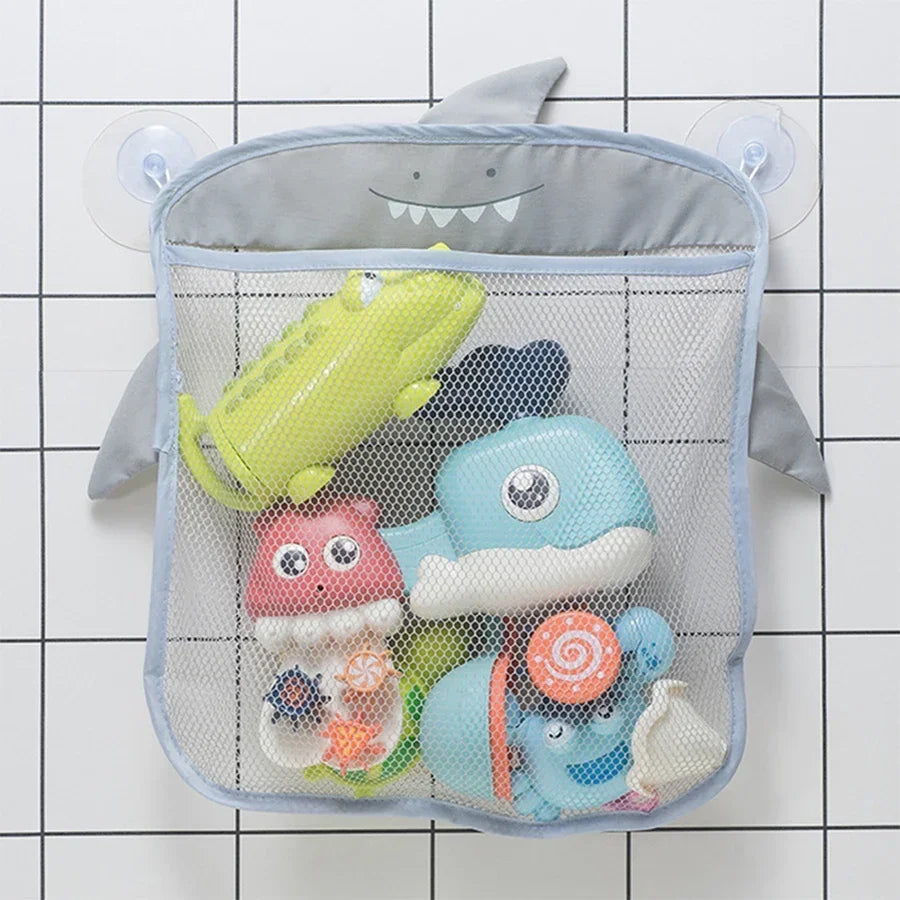 A gray organizer bag with a mesh net filled with various colorful toddler bath toys.