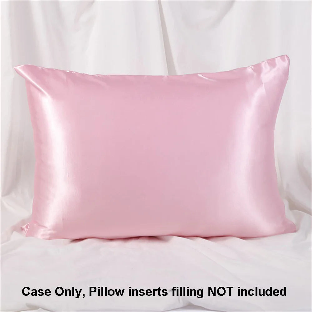 A smooth pink satin pillowcase is shown lying flat against a white background.