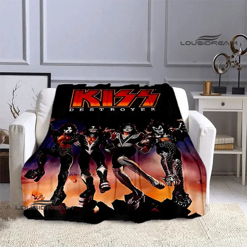 A black printed flannel travel blanket featuring a graphic of three stylized characters in an action pose.