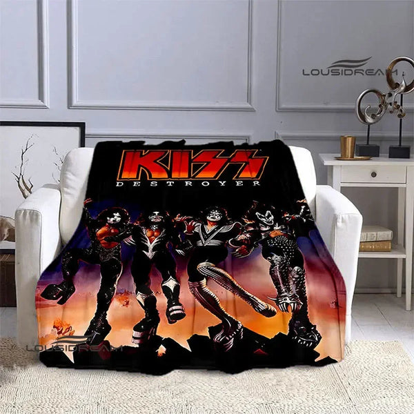 A black printed flannel travel blanket featuring a graphic of three stylized characters in an action pose.