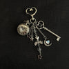 Silver star pocket watch keychain with an adjustable clock and decorative charms