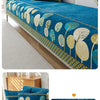 A deep blue jacquard sofa seat and back cover featuring a pattern of gold and green leaves.