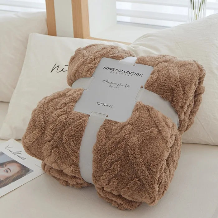 A fluffy brown throw blanket is presented with a gift tag on a white surface.