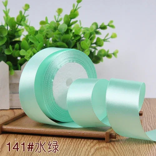 Roll of light mint green satin ribbon for gift wrapping and DIY crafts