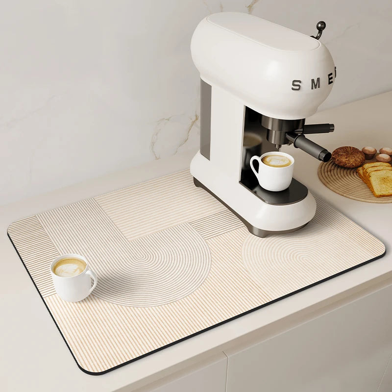 A white electric coffee grinder sits on a beige mat with concentric circles and vertical stripes.