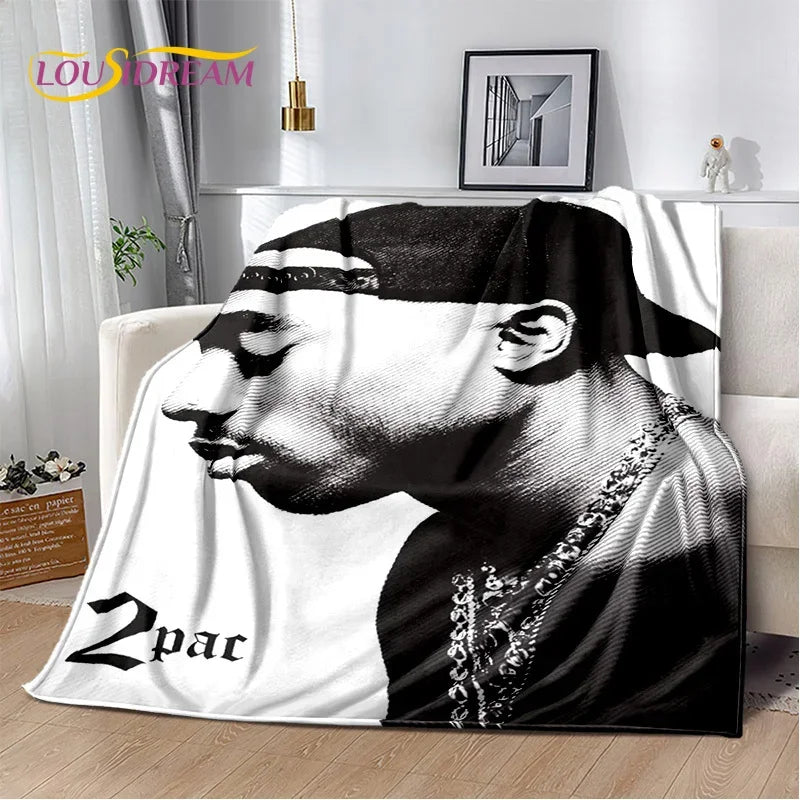 A black and white graphic print of a man's profile on a throw blanket.