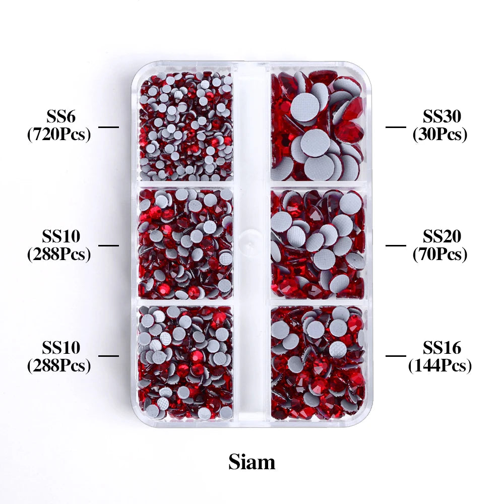 A clear plastic tray containing various sizes of red and silver glass rhinestones categorized by SS6, SS10, SS10, SS30, SS20,
